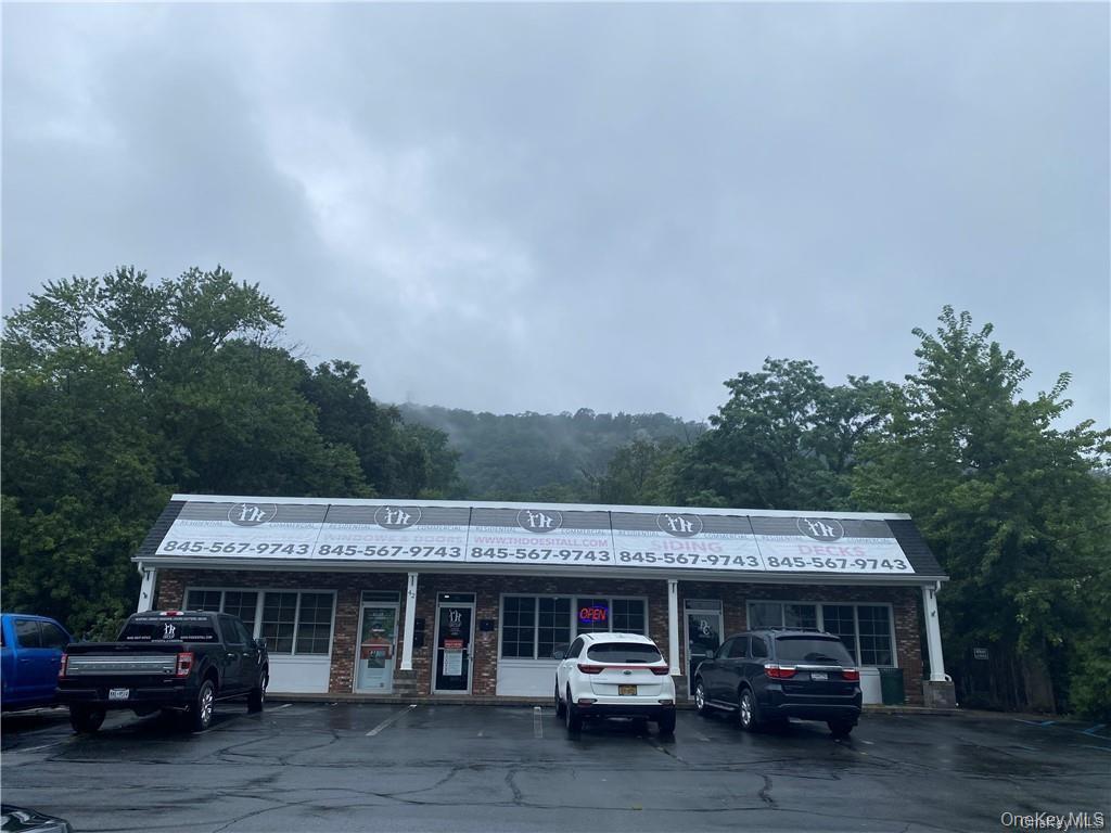 View of commercial location featuring uncovered parking