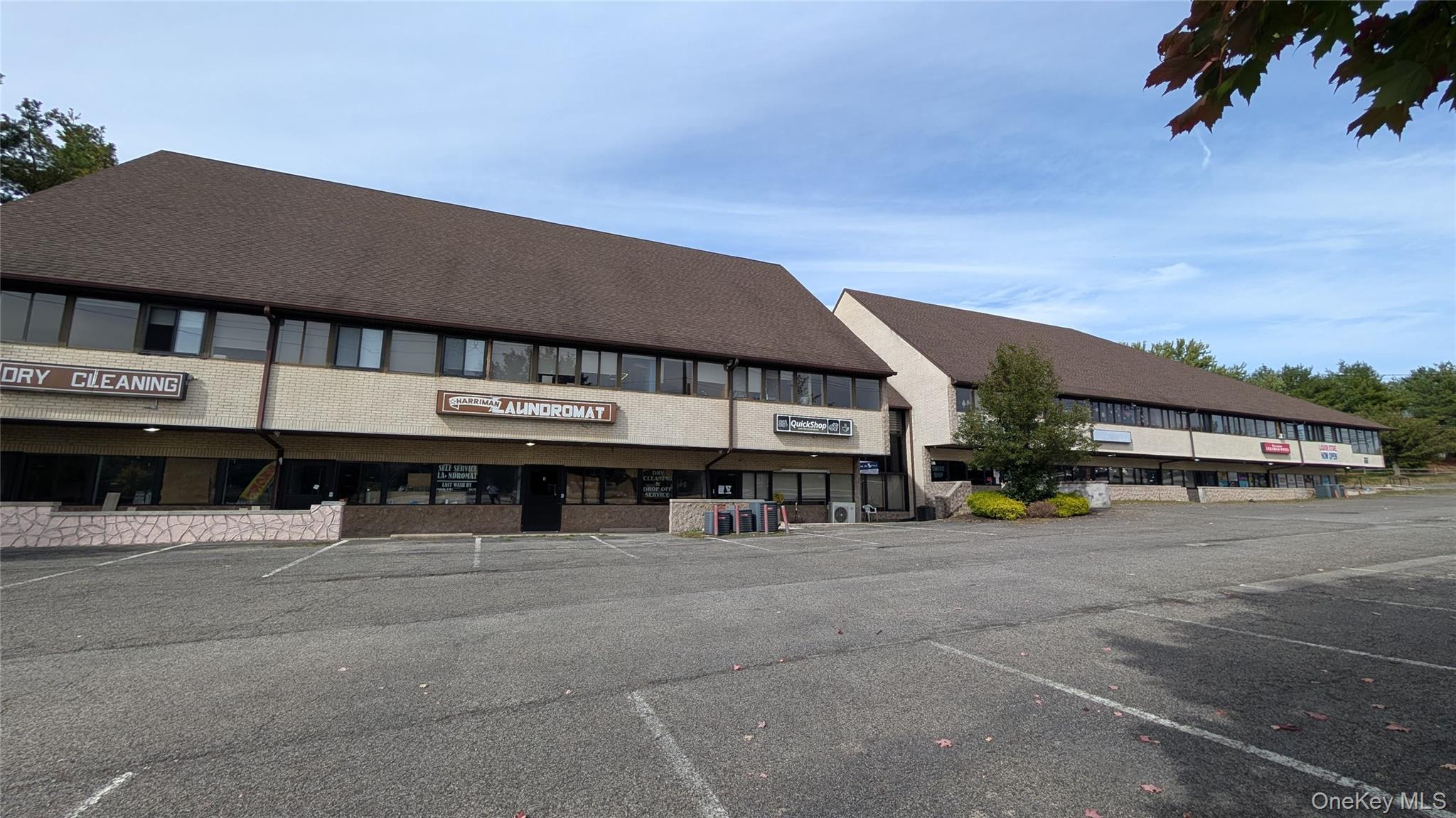 View of building exterior with uncovered parking