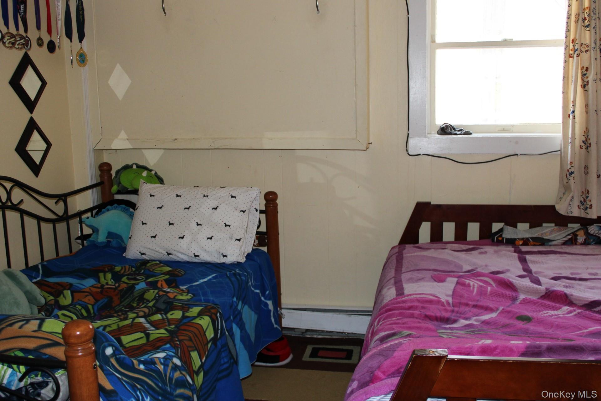 Bonus room featuring a baseboard radiator