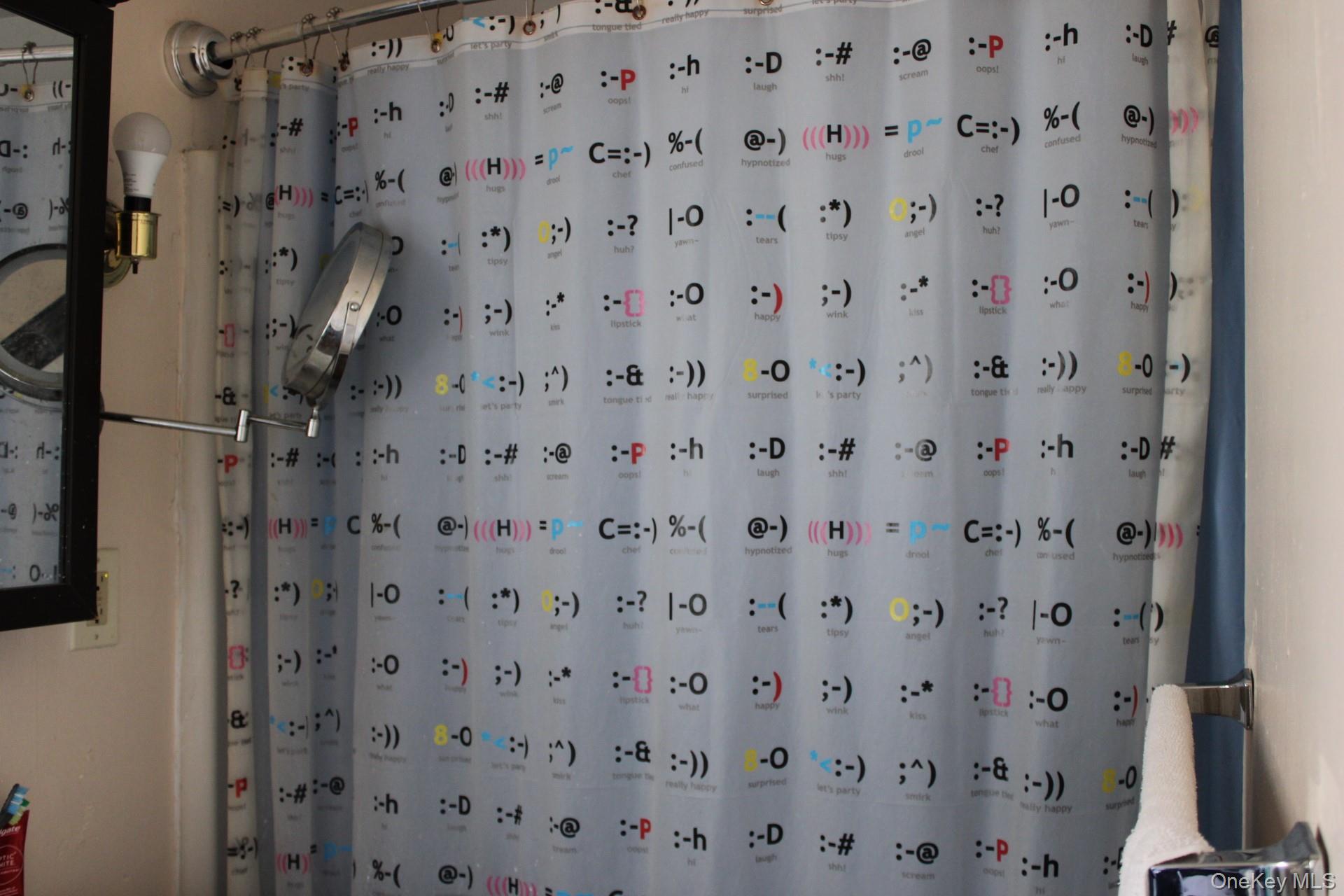 Bathroom featuring curtained shower