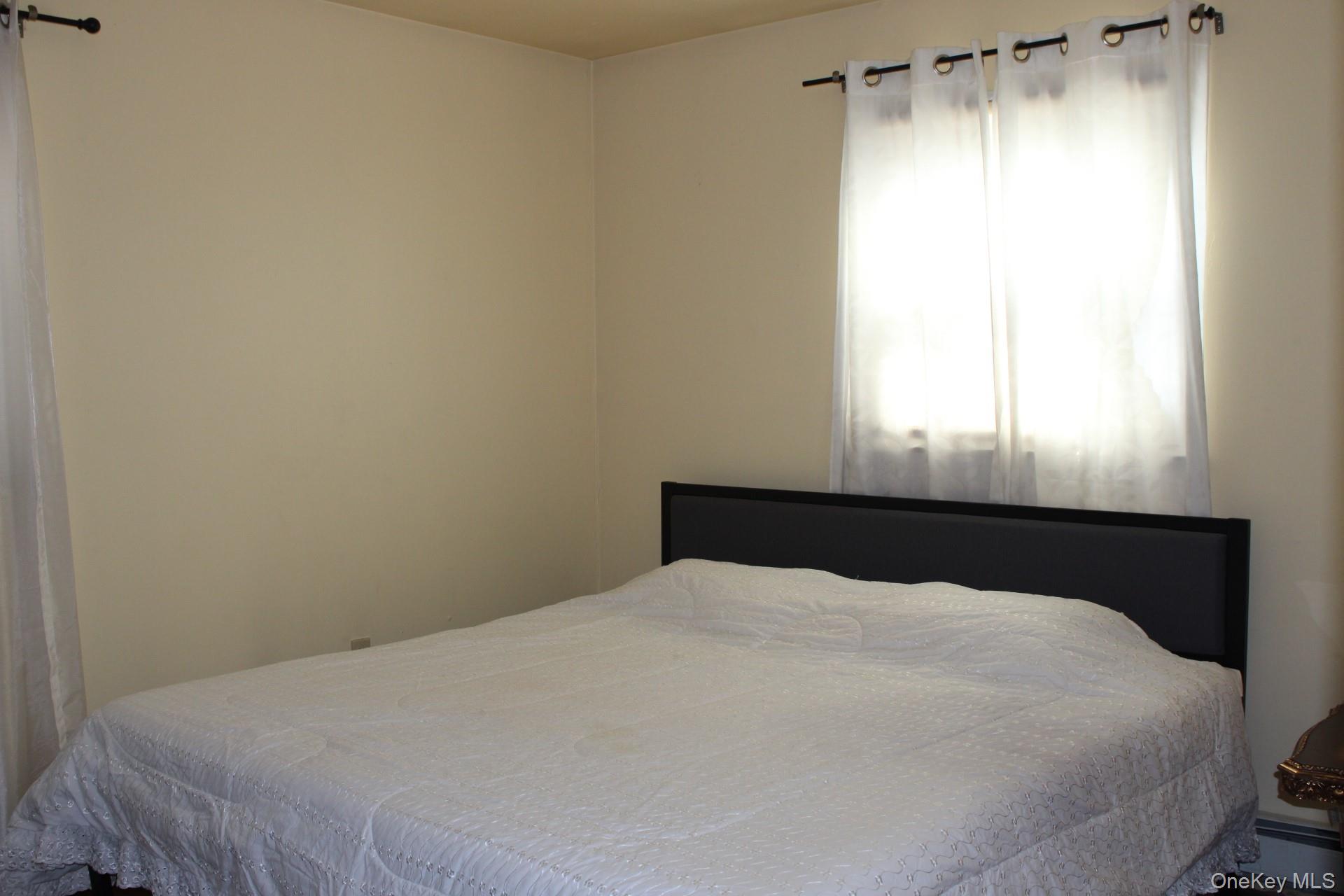 Bedroom featuring a baseboard radiator