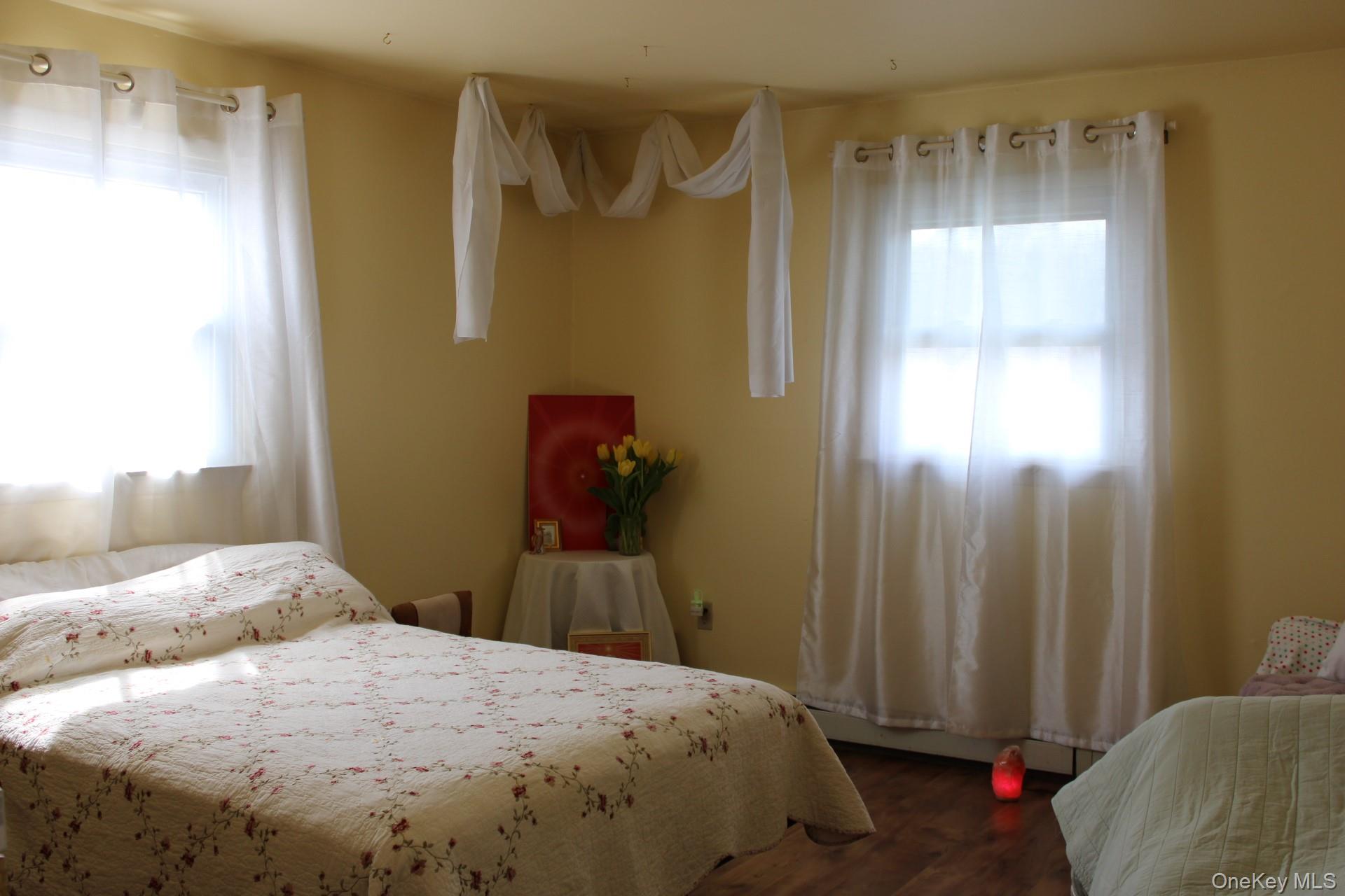 Bedroom featuring dark wood-type flooring