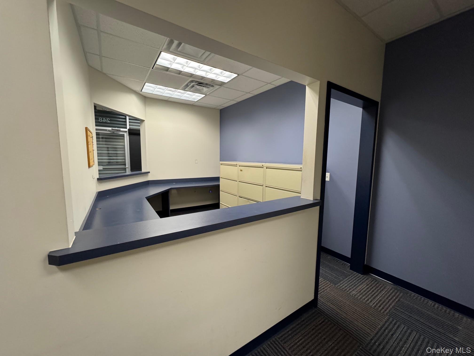 Unfurnished office featuring a drop ceiling