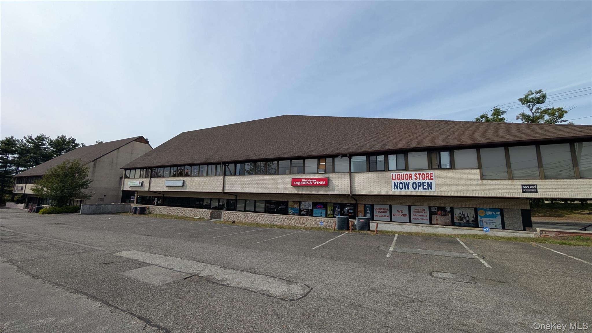View of property featuring uncovered parking