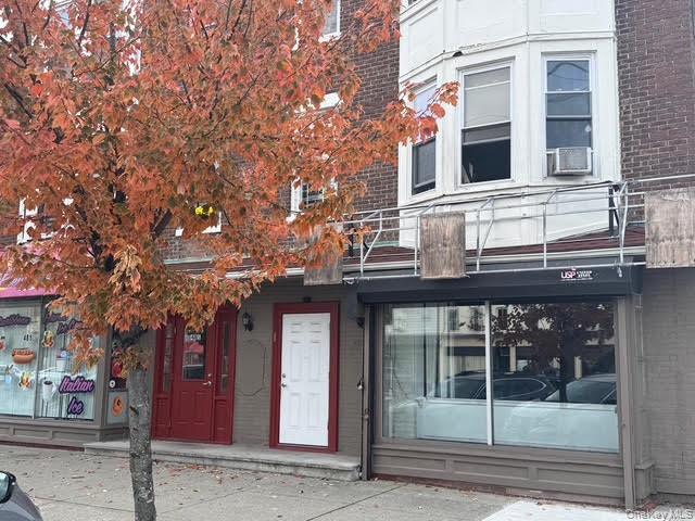 View of exterior entry featuring brick siding