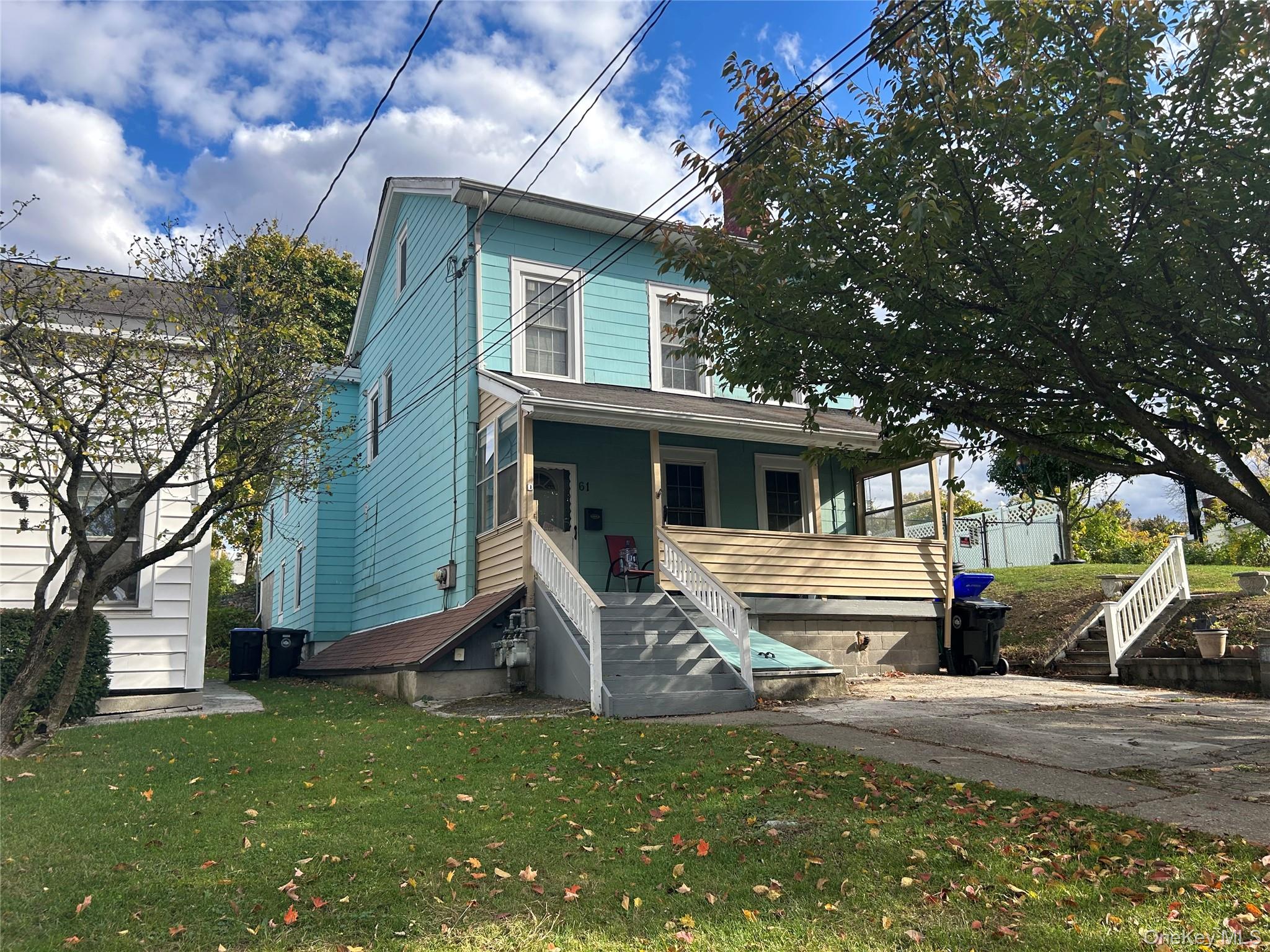 View of front of property featuring a front lawn and a porch