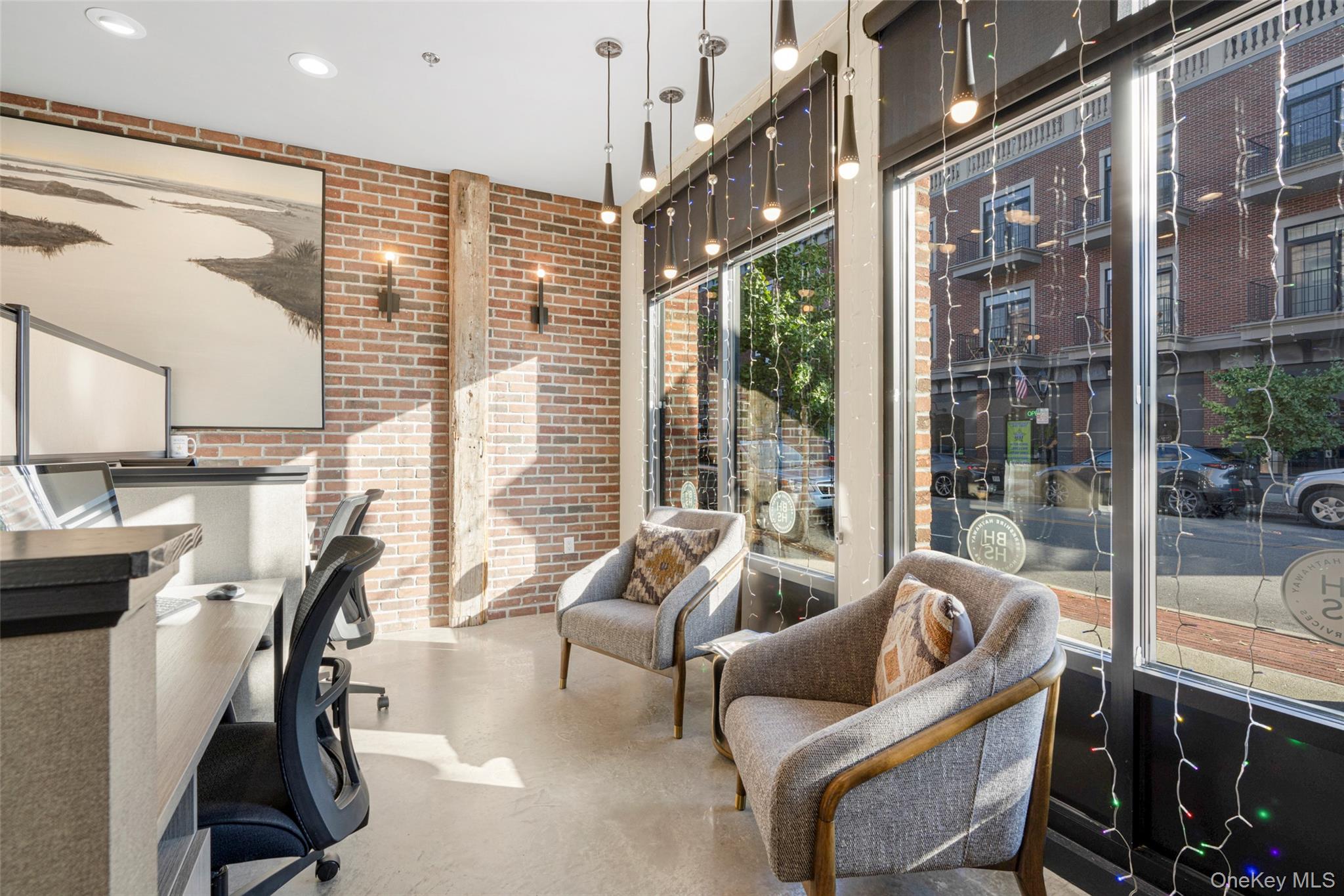 Office area with brick wall and recessed lighting