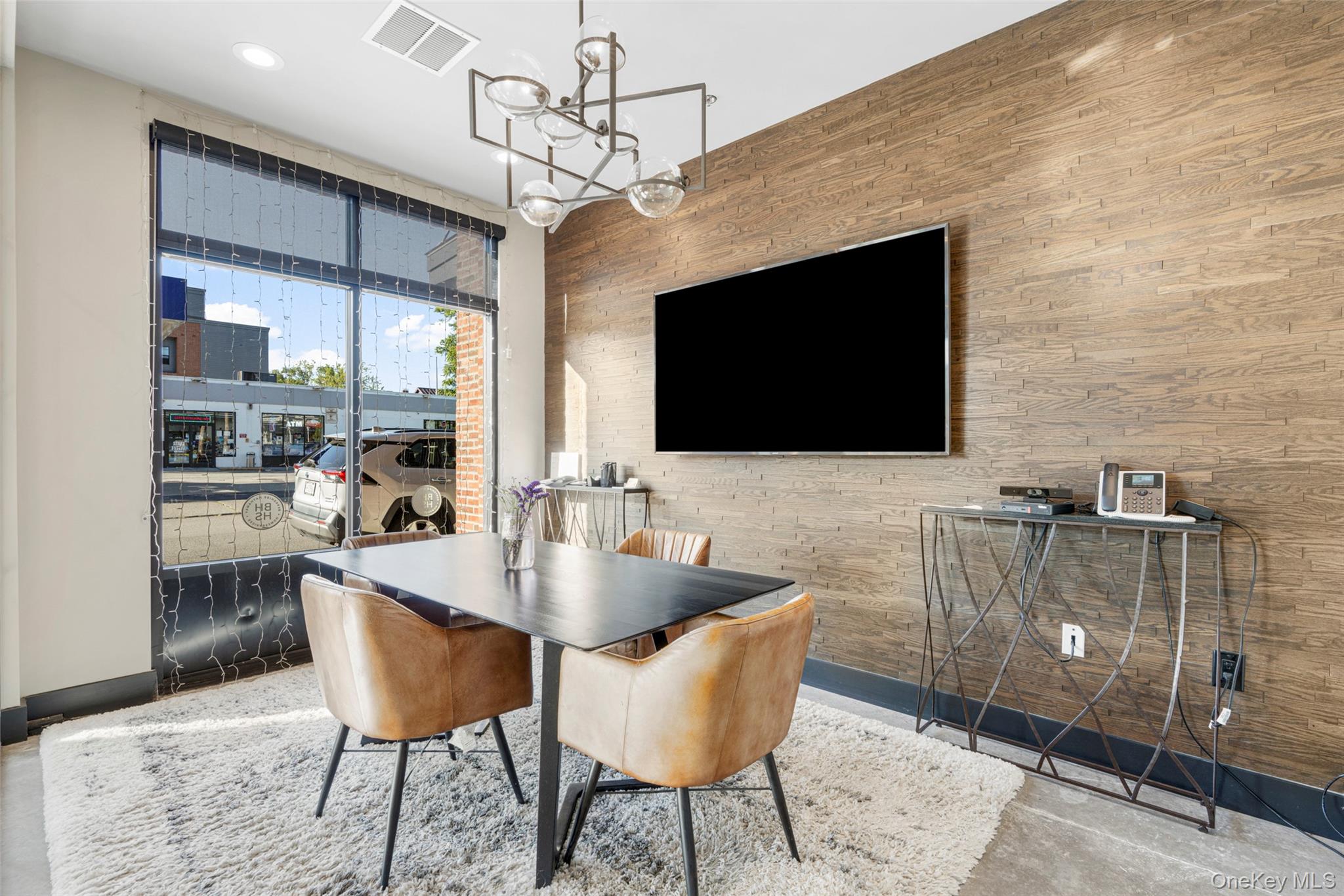Dining space featuring a chandelier and concrete flooring