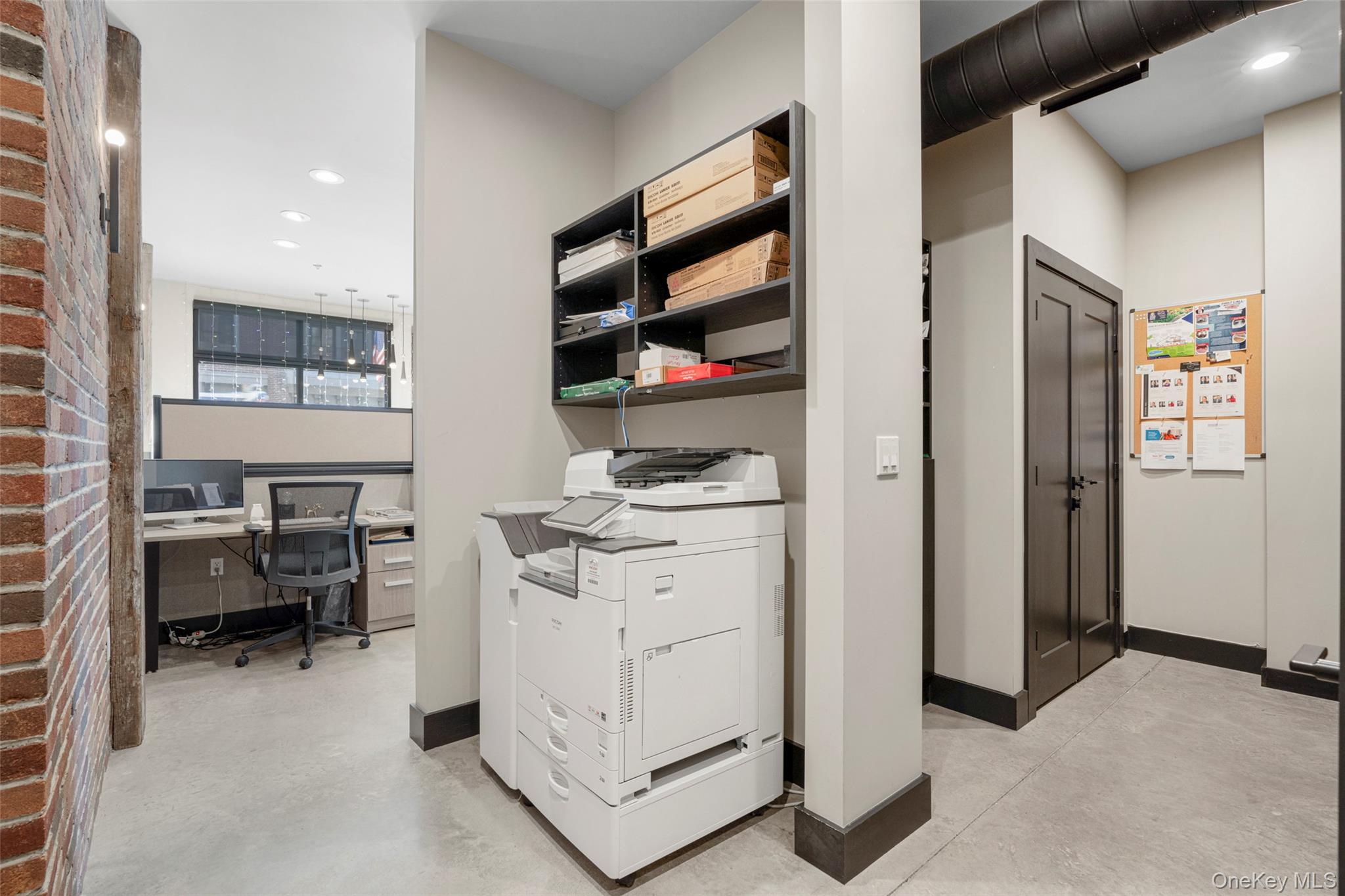 Office featuring finished concrete flooring and recessed lighting