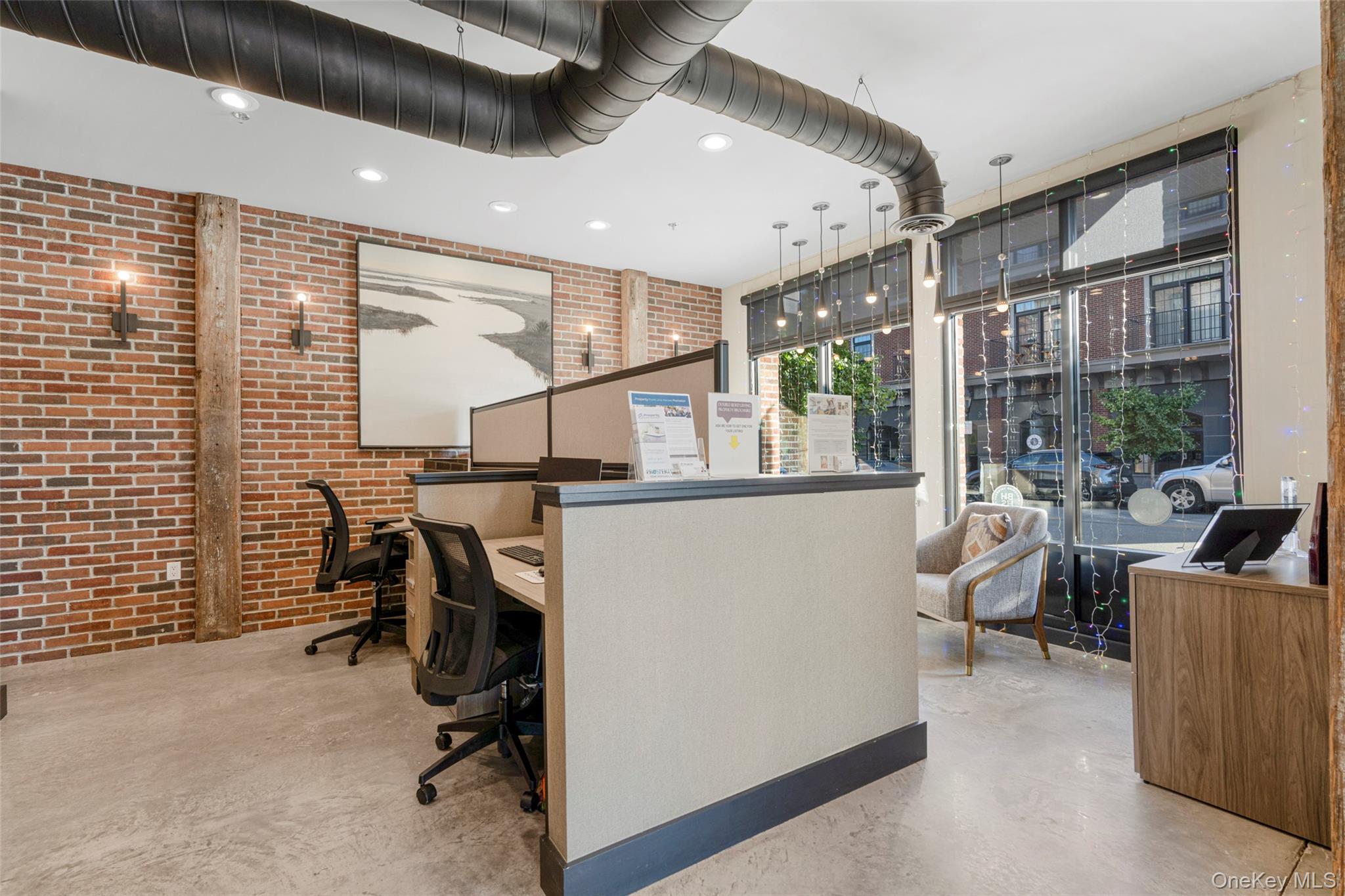 Office featuring brick wall and recessed lighting