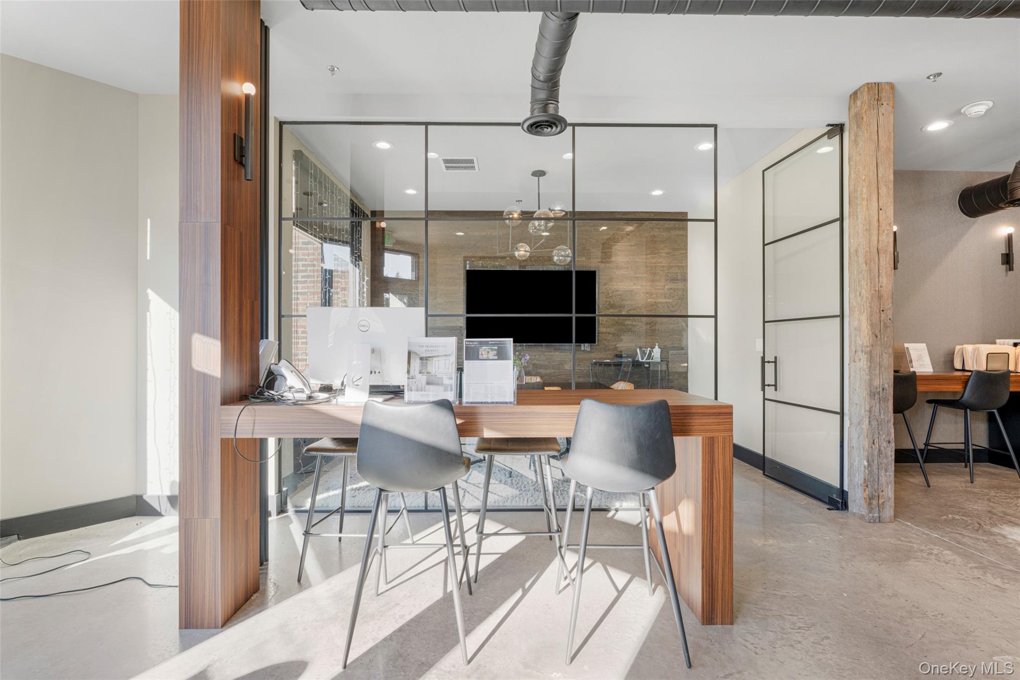 Dining area featuring a desk, finished concrete floors, and recessed lighting
