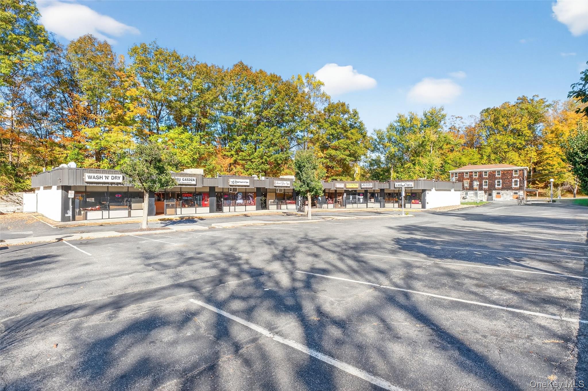 View of commercial property with uncovered parking