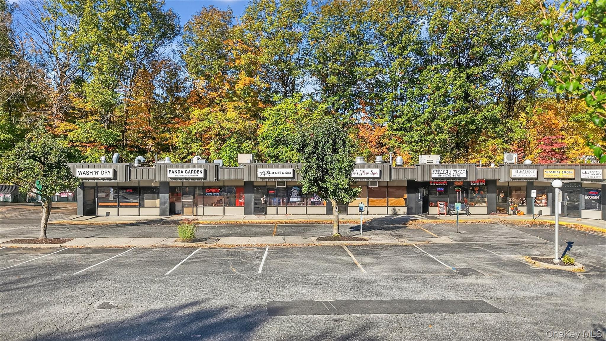 View of commercial location featuring uncovered parking