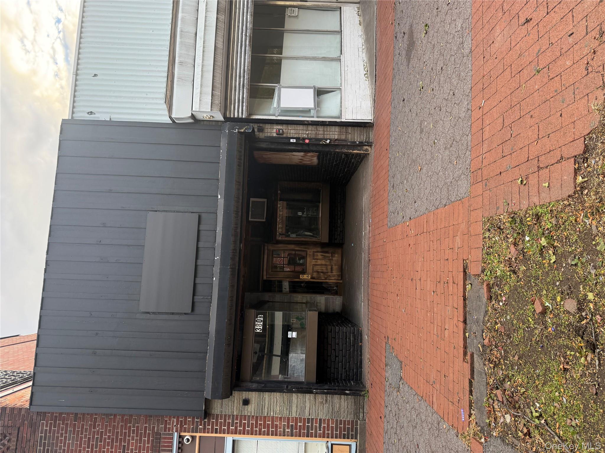 View of exterior entry featuring brick siding