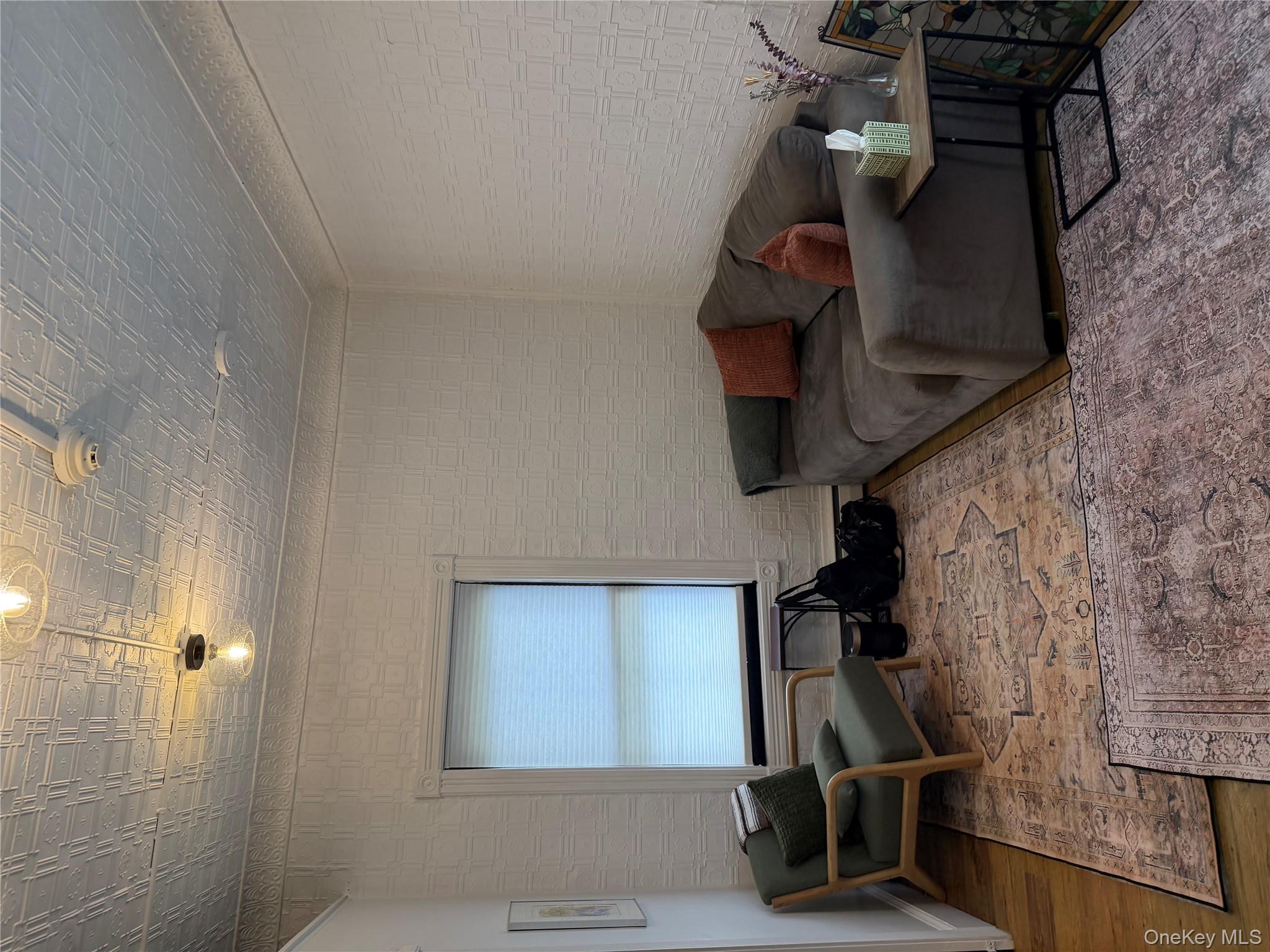 Living room featuring wood finished floors and an ornate ceiling