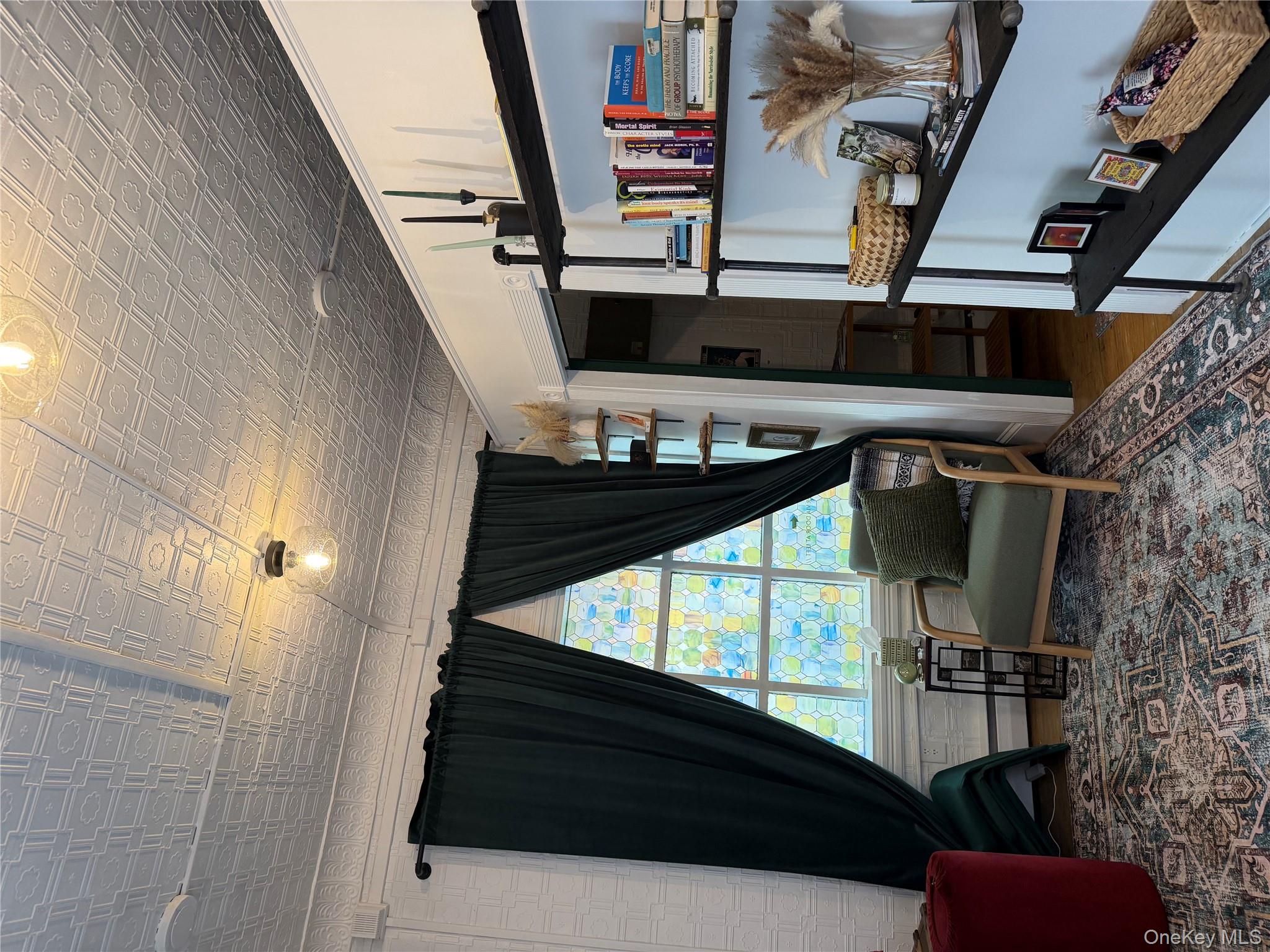 Living area featuring wood finished floors and an ornate ceiling