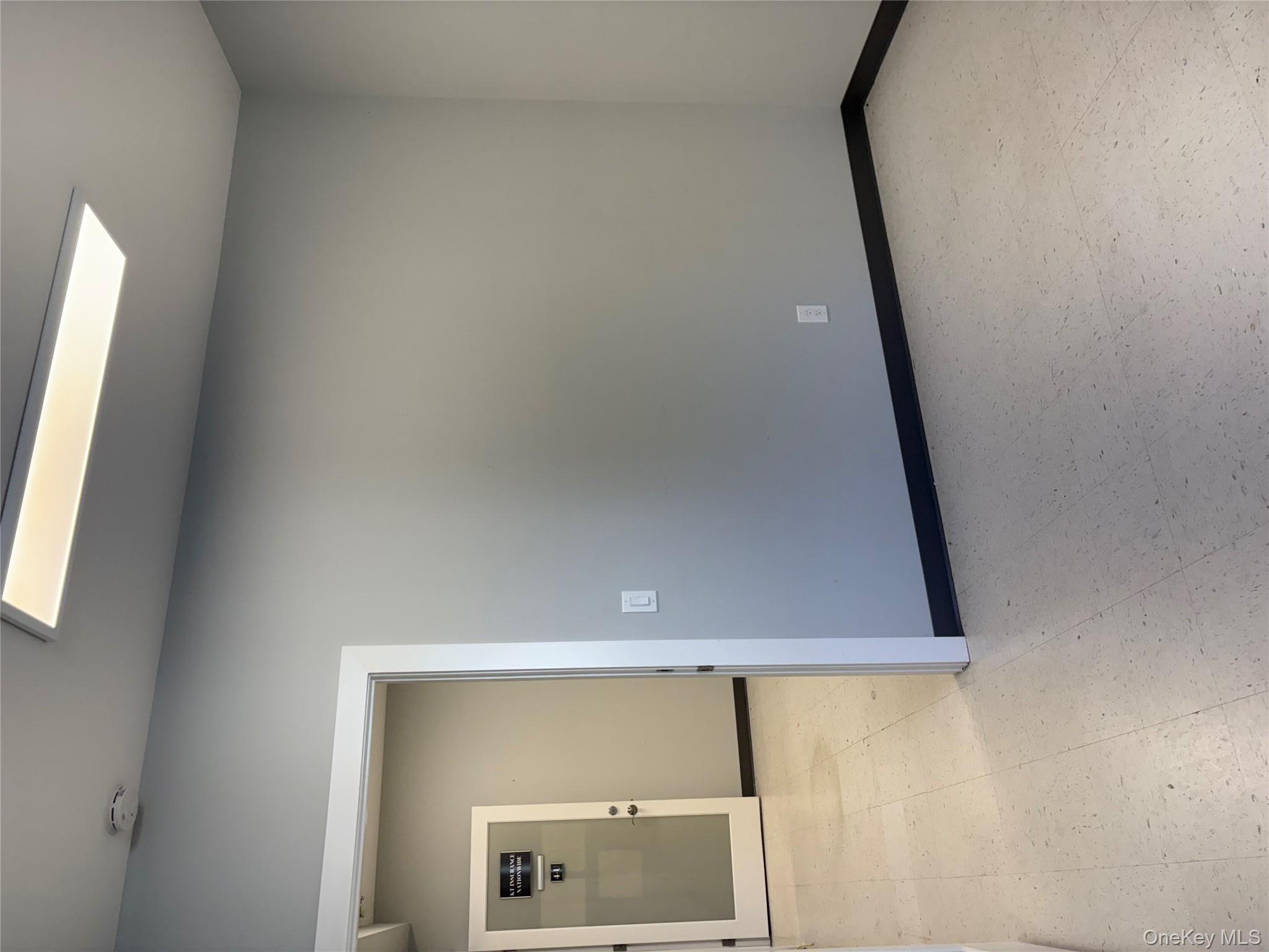 Unfurnished room featuring baseboards and light flooring