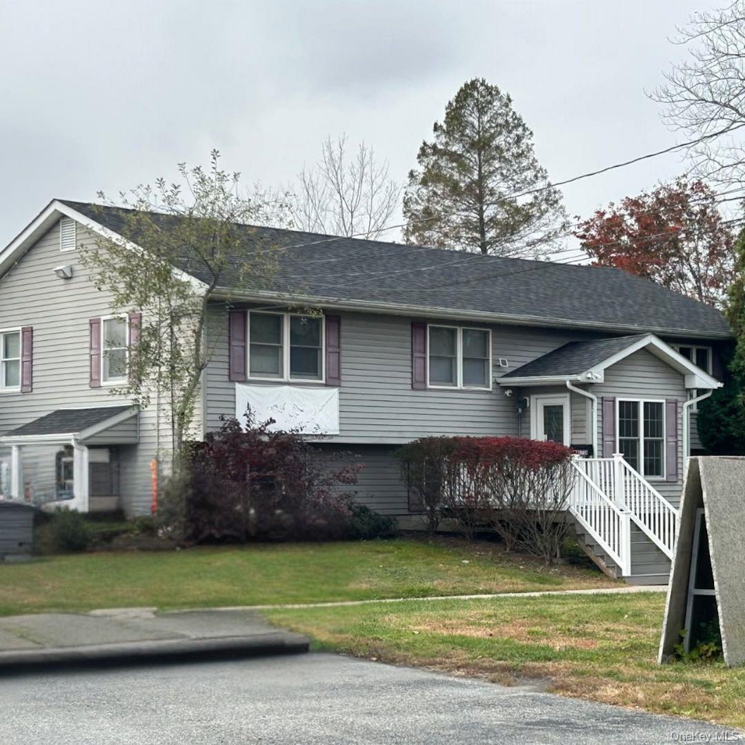 View of front of house with a front lawn and a deck