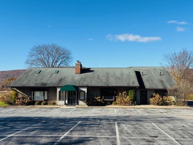 View of property with uncovered parking