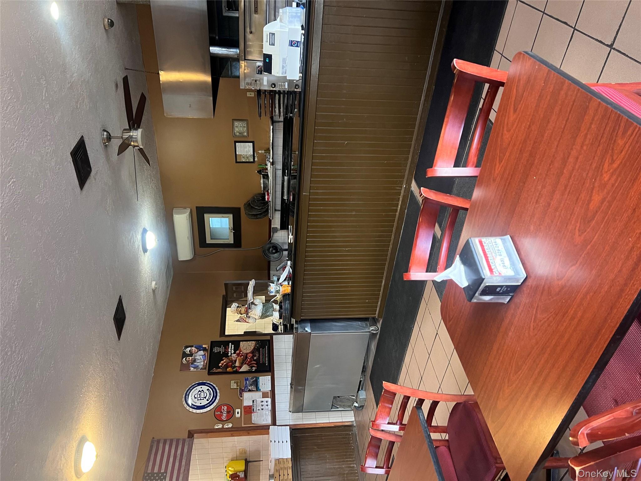 Dining space with light tile patterned floors, a textured ceiling, and a ceiling fan