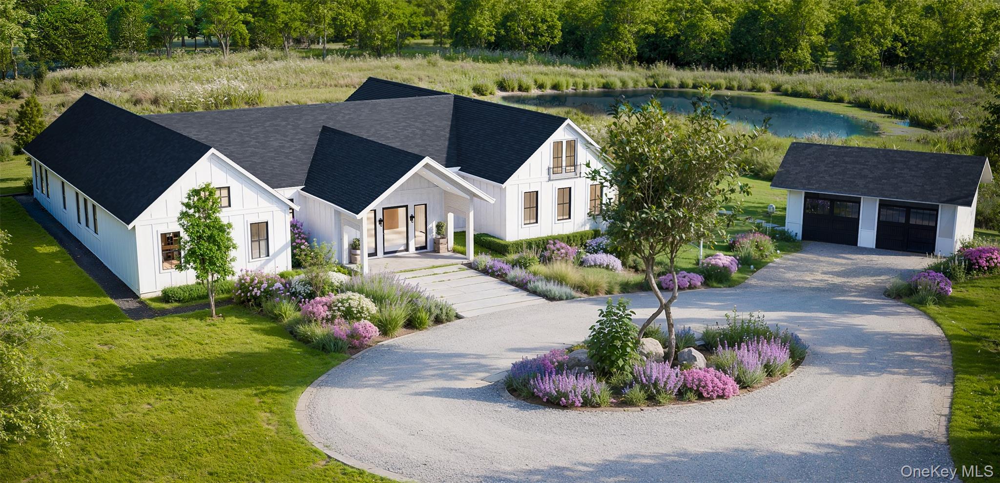 View of front of house with an outbuilding, a front lawn, board and batten siding, curved driveway, and a shingled roof
