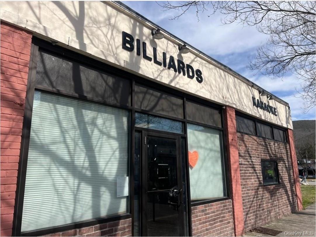 Doorway to property featuring brick siding