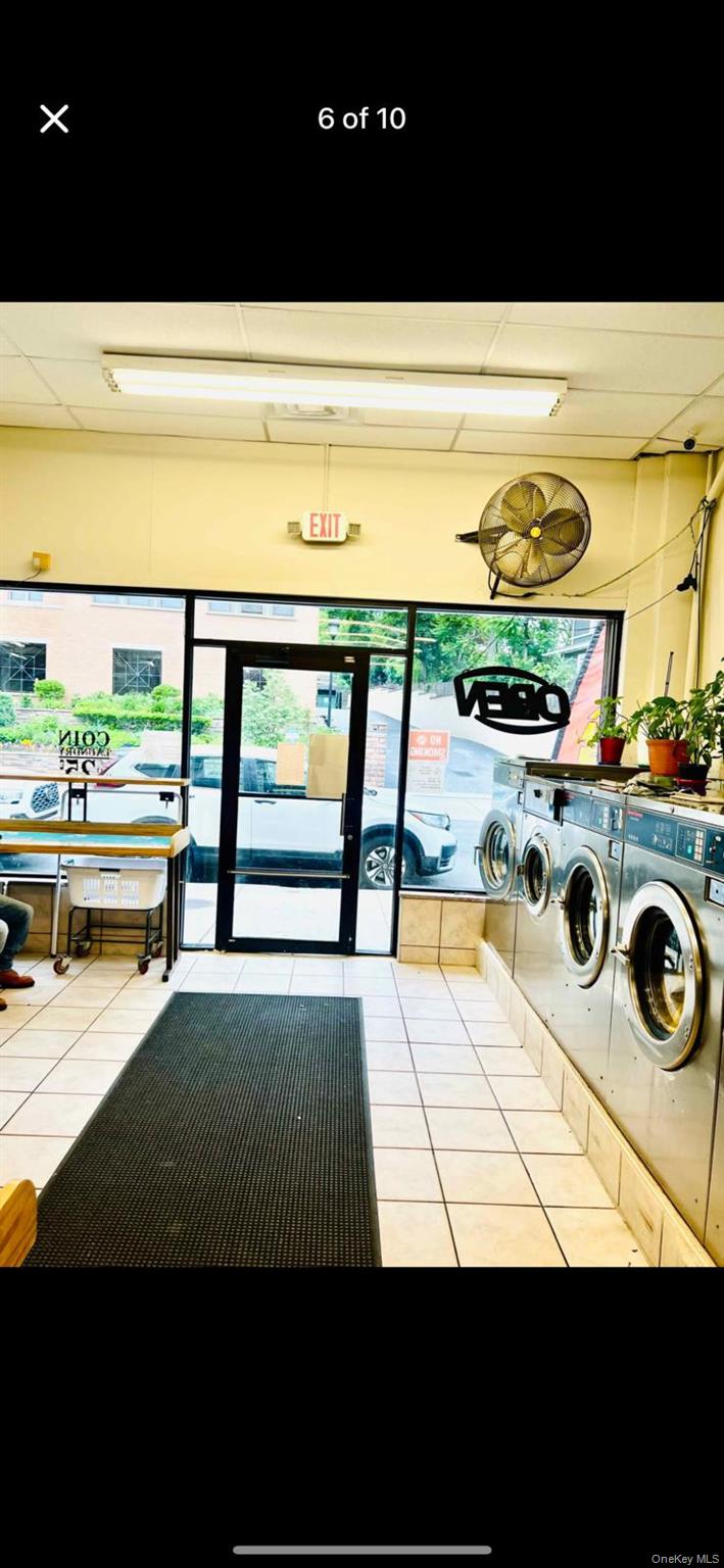Community laundry with a paneled ceiling and washer and clothes dryer