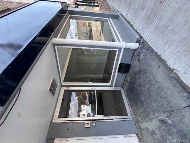 View of exterior entry with a patio area