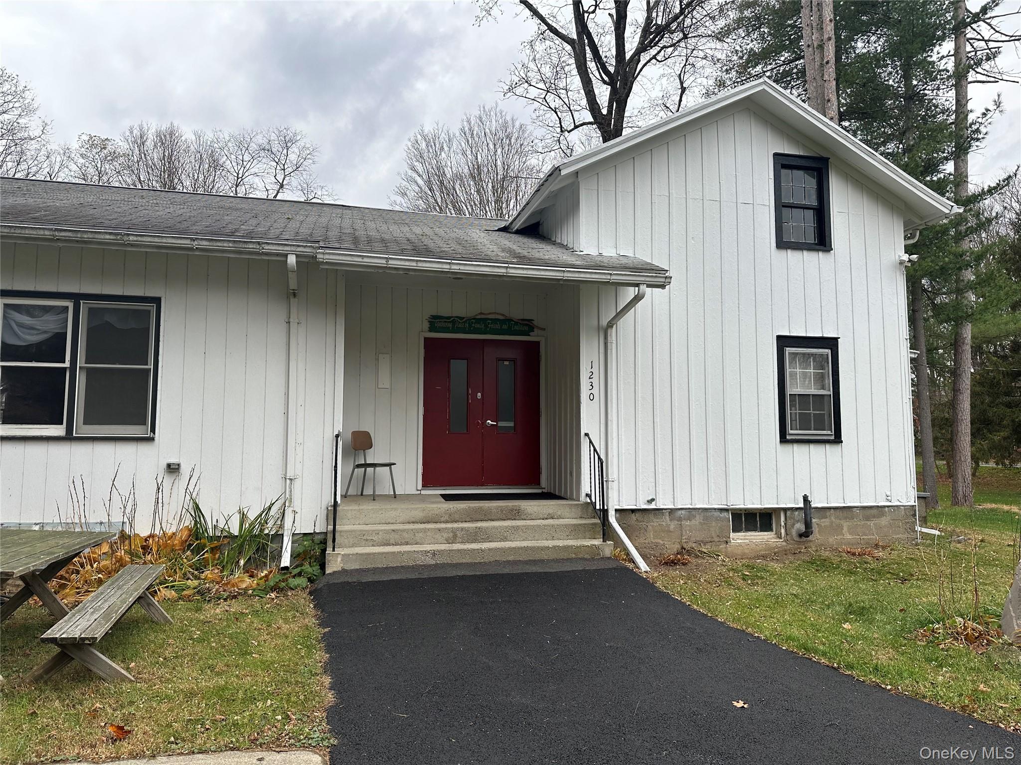 Entrance to property with a shingled roof