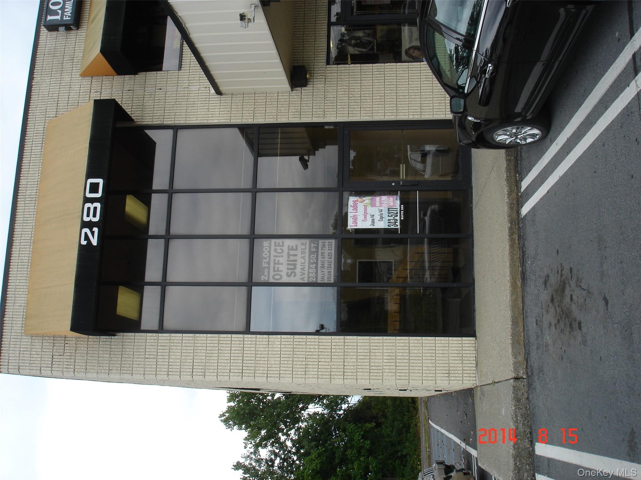 View of property with uncovered parking