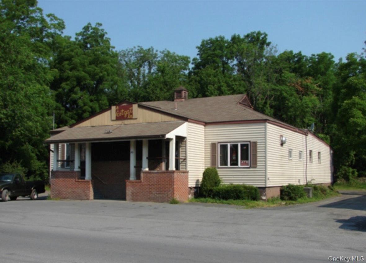 Bungalow-style house with a chimney and a porch