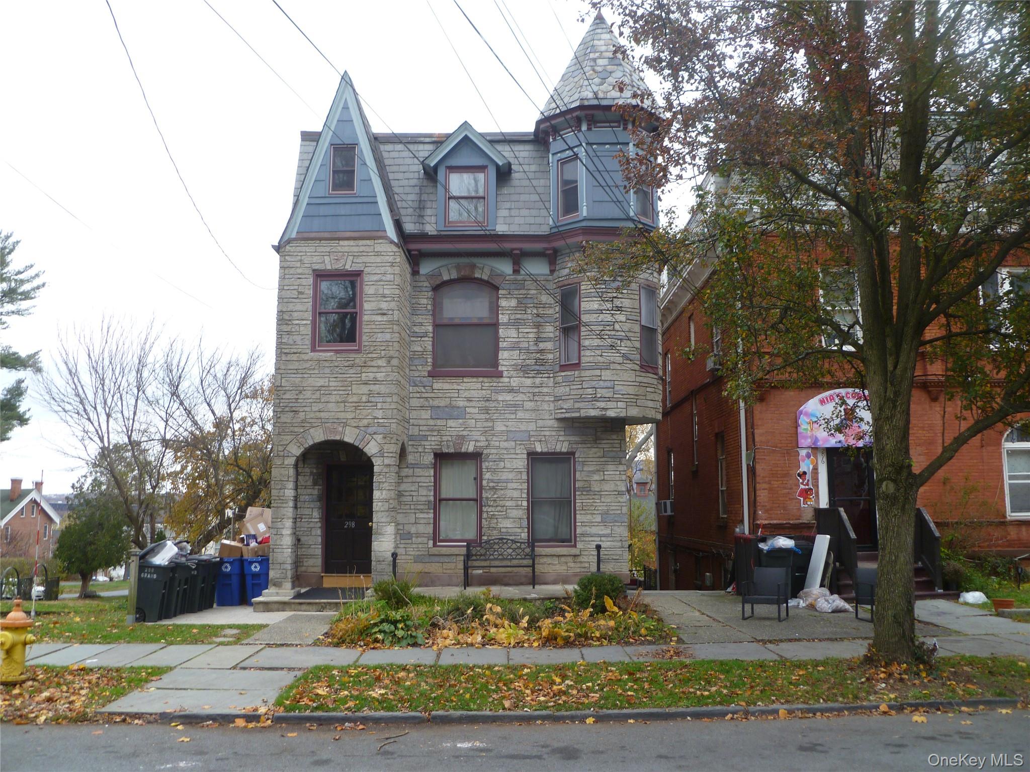 View of front facade featuring a high end roof and stone siding
