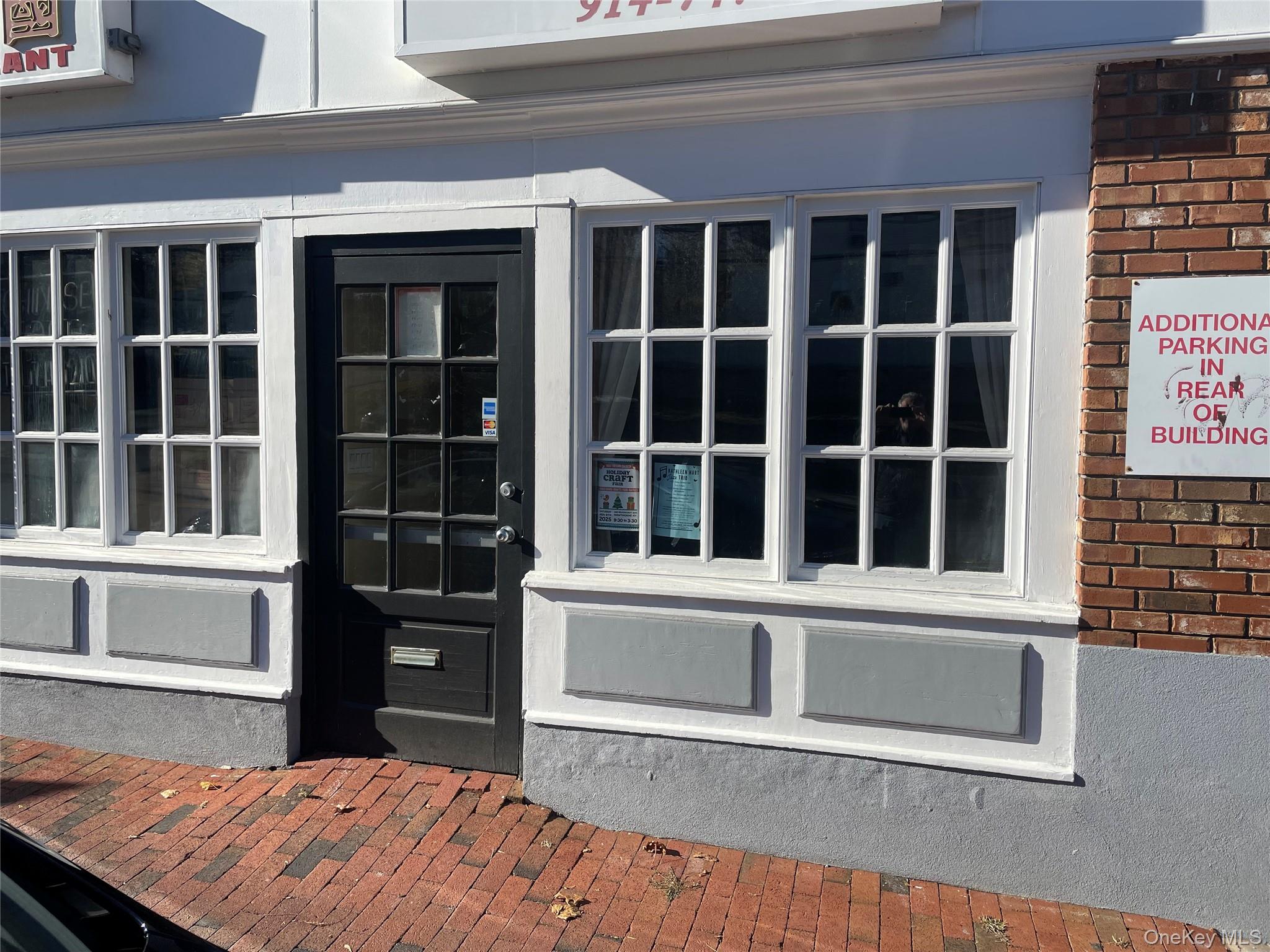 Doorway to property with brick siding