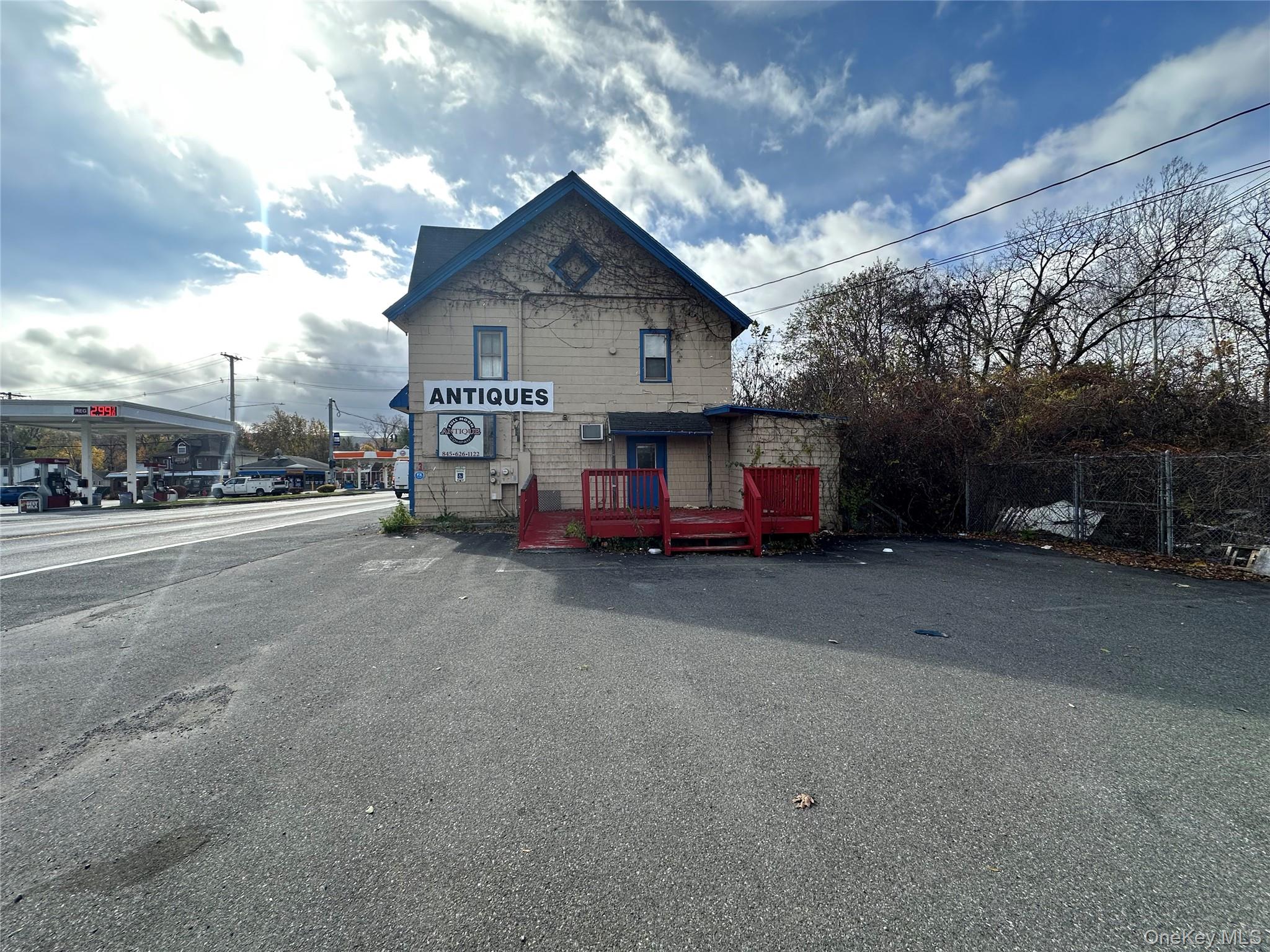 View of front facade featuring a wooden deck