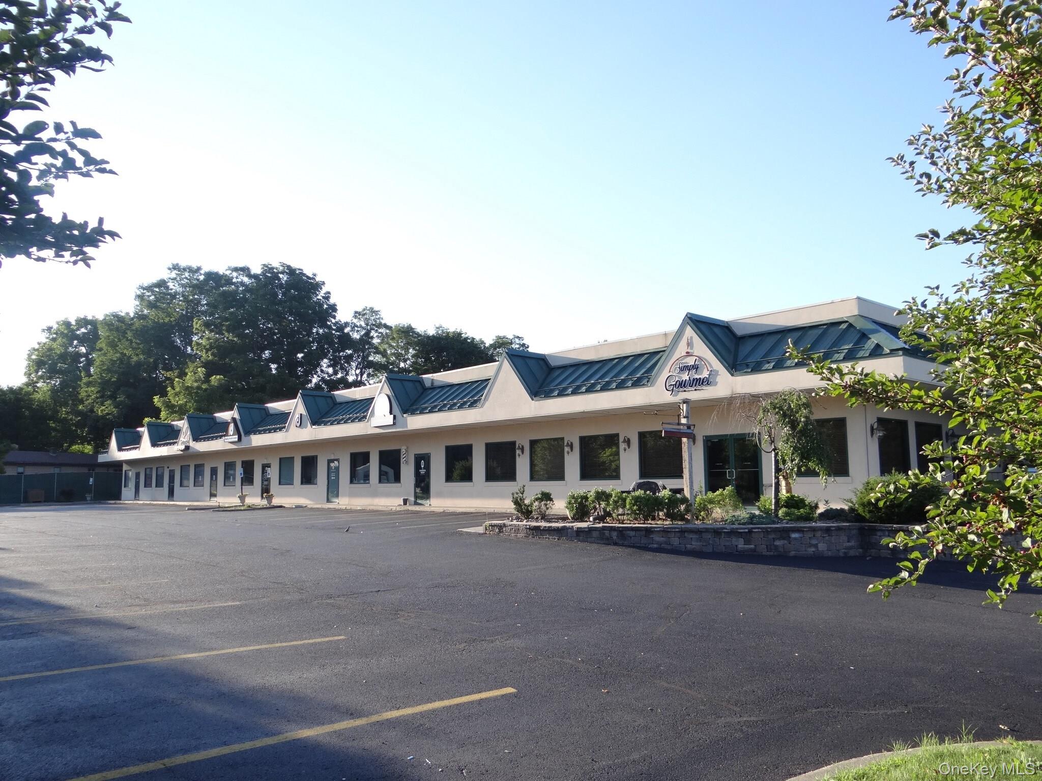 View of property with uncovered parking