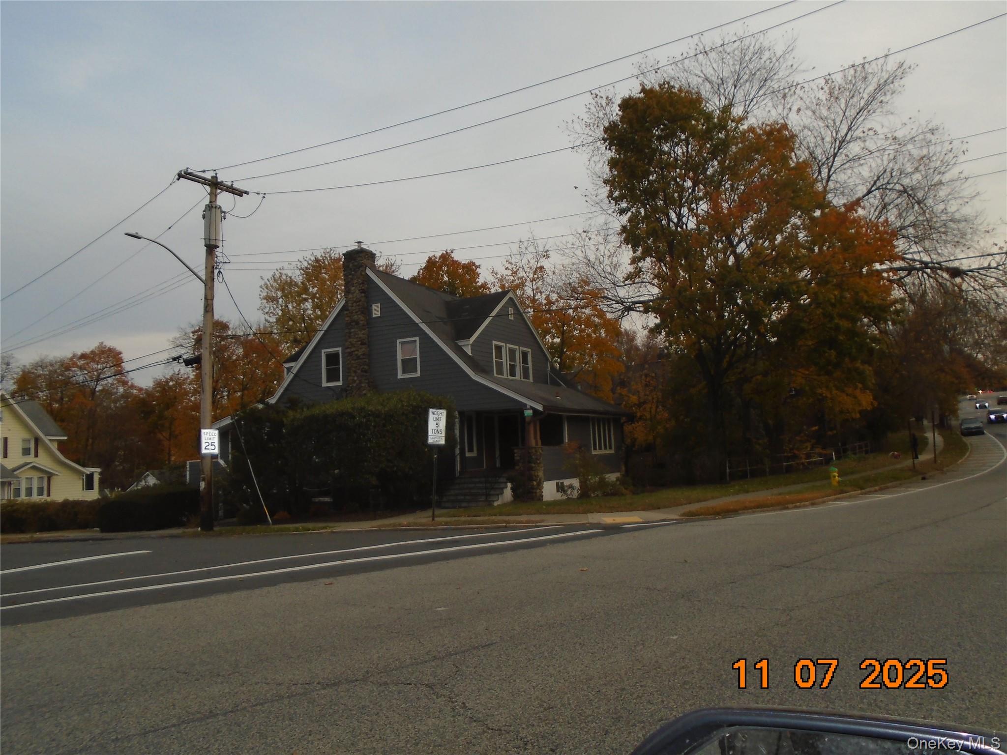 View of front of property featuring a porch and a chimney