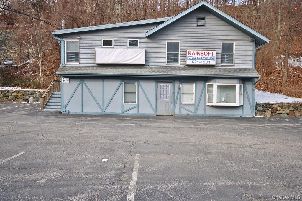 View of front of house featuring a shingled roof