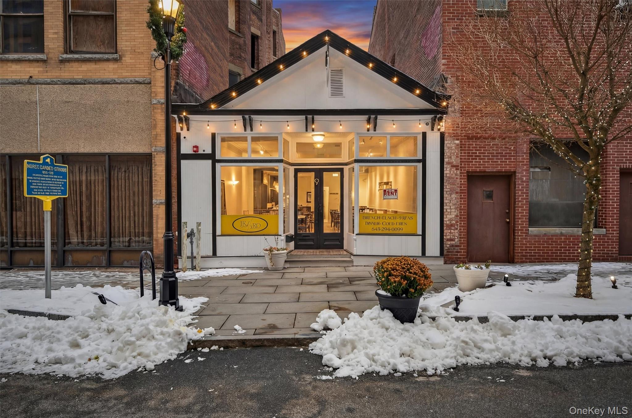View of front of house featuring french doors and brick siding