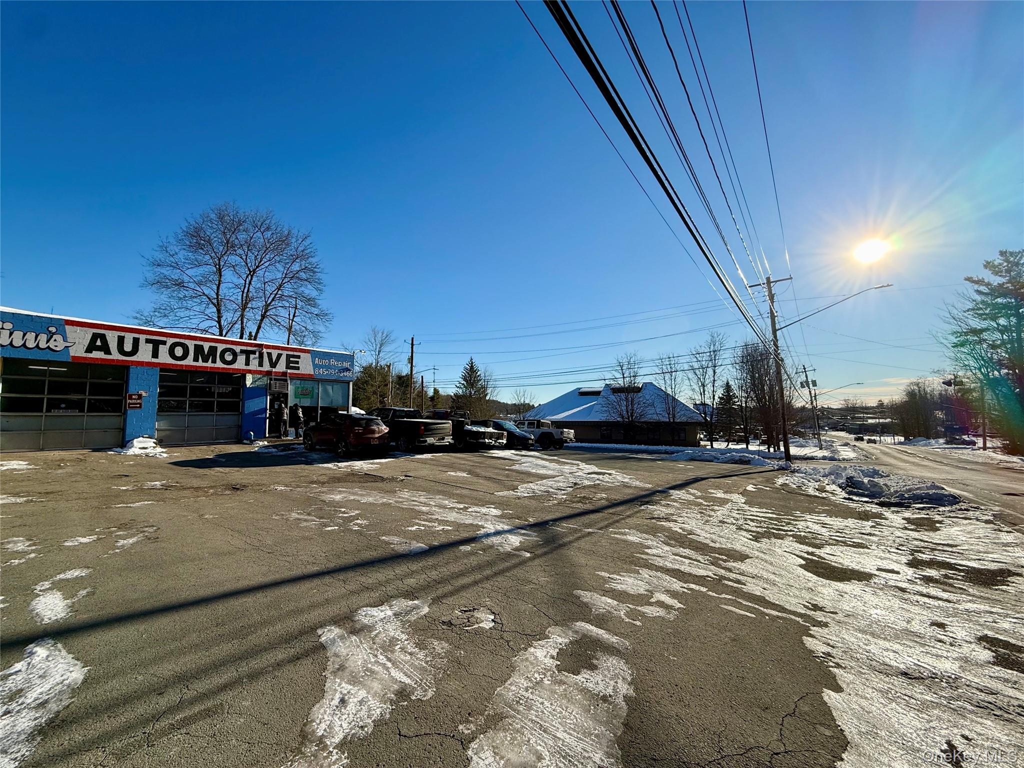View of asphalt road featuring street lights