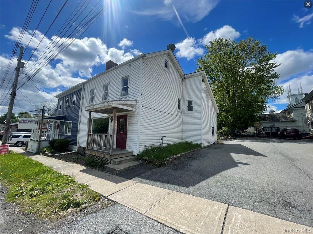 View of property exterior featuring a chimney