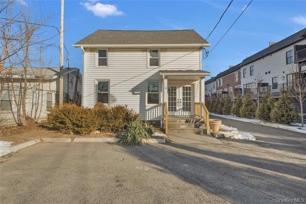 View of front facade with a shingled roof