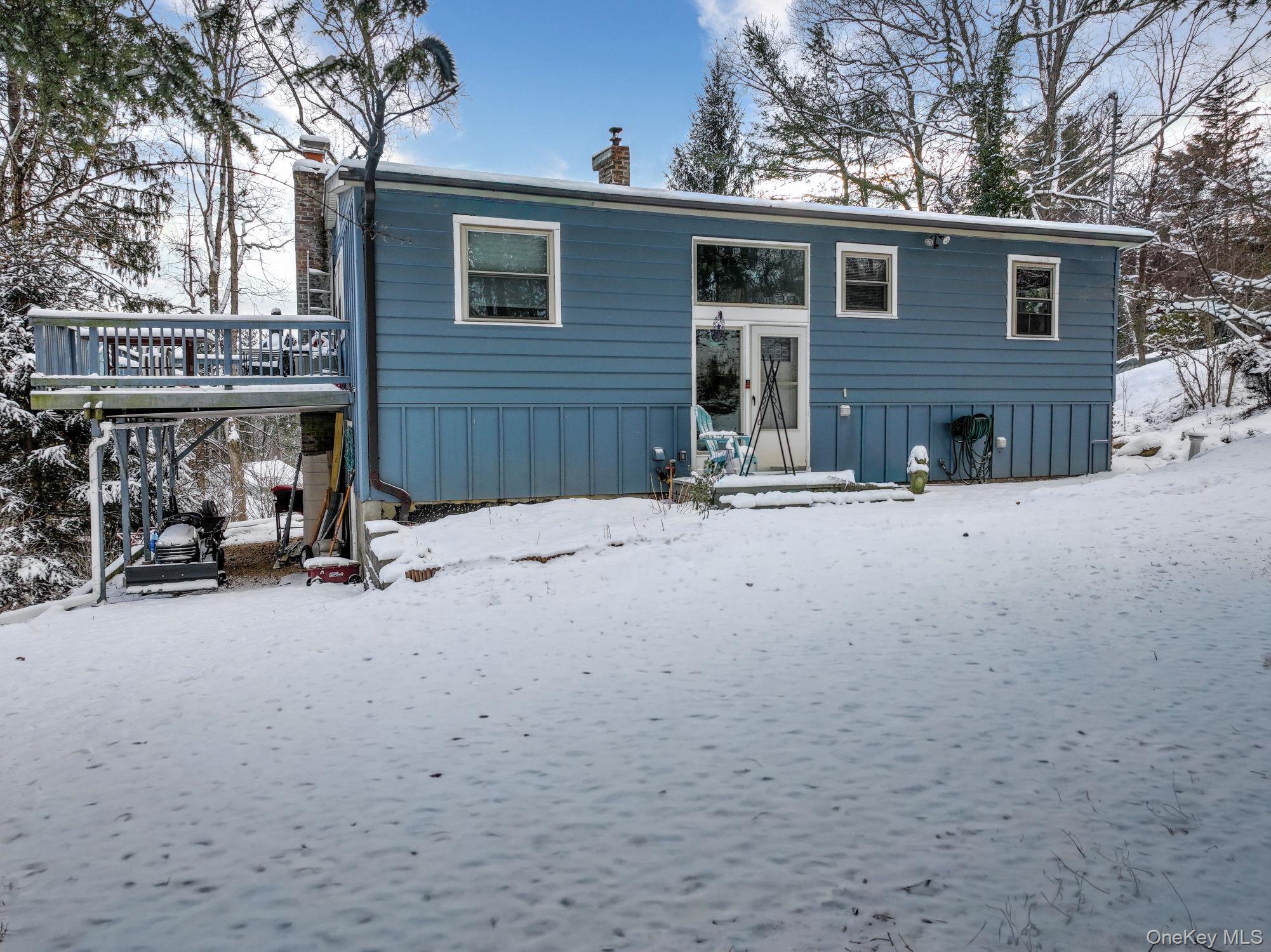 Snow covered property featuring a chimney