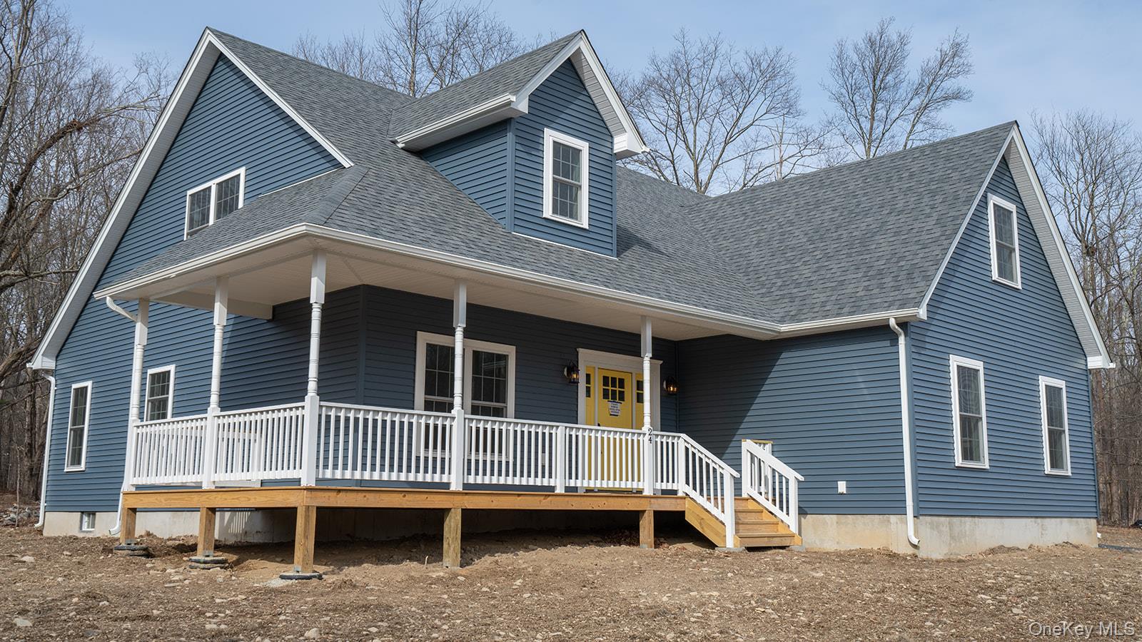View of front of house with a large porch and roof with shingles