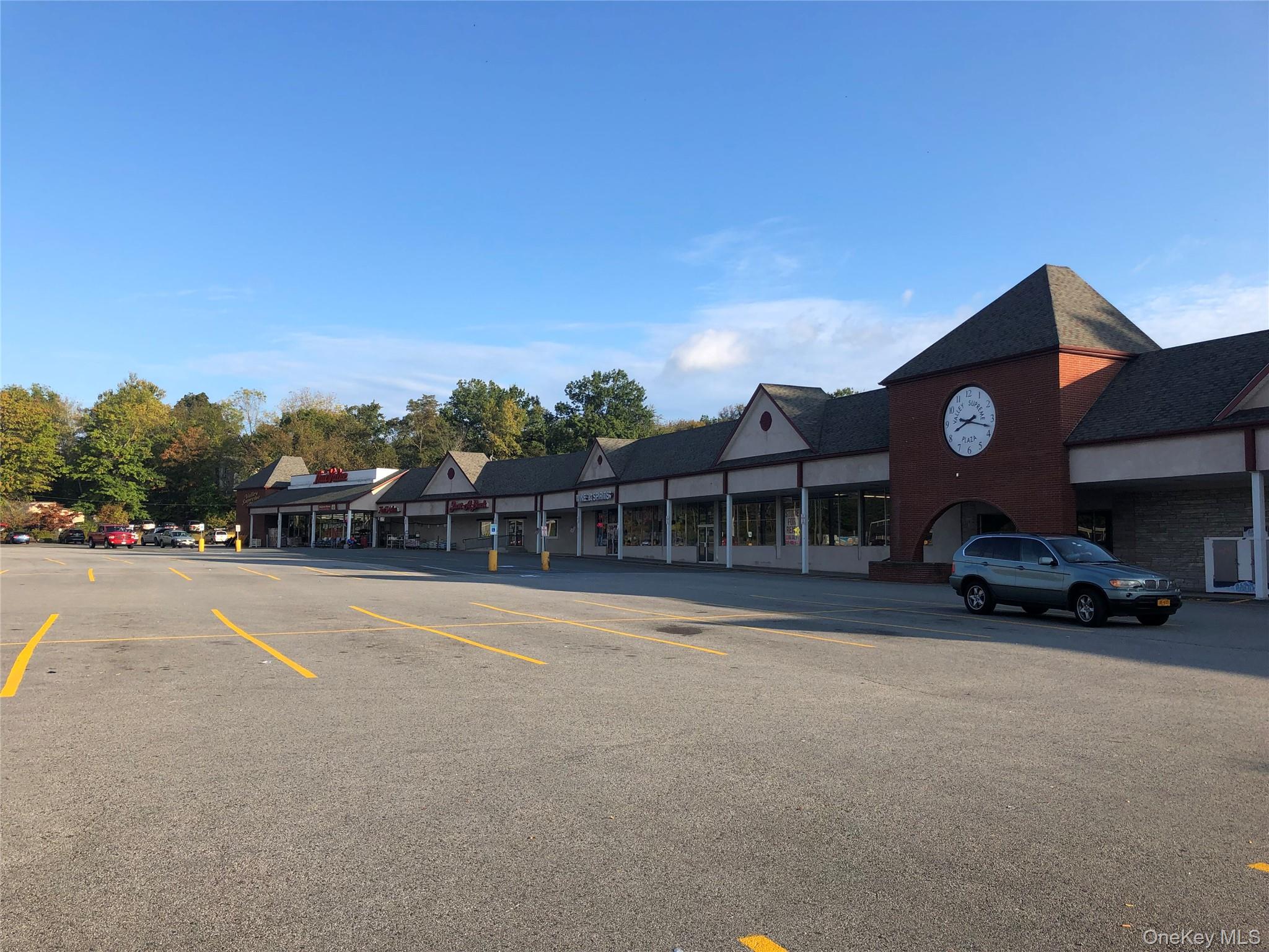 View of commercial property with uncovered parking