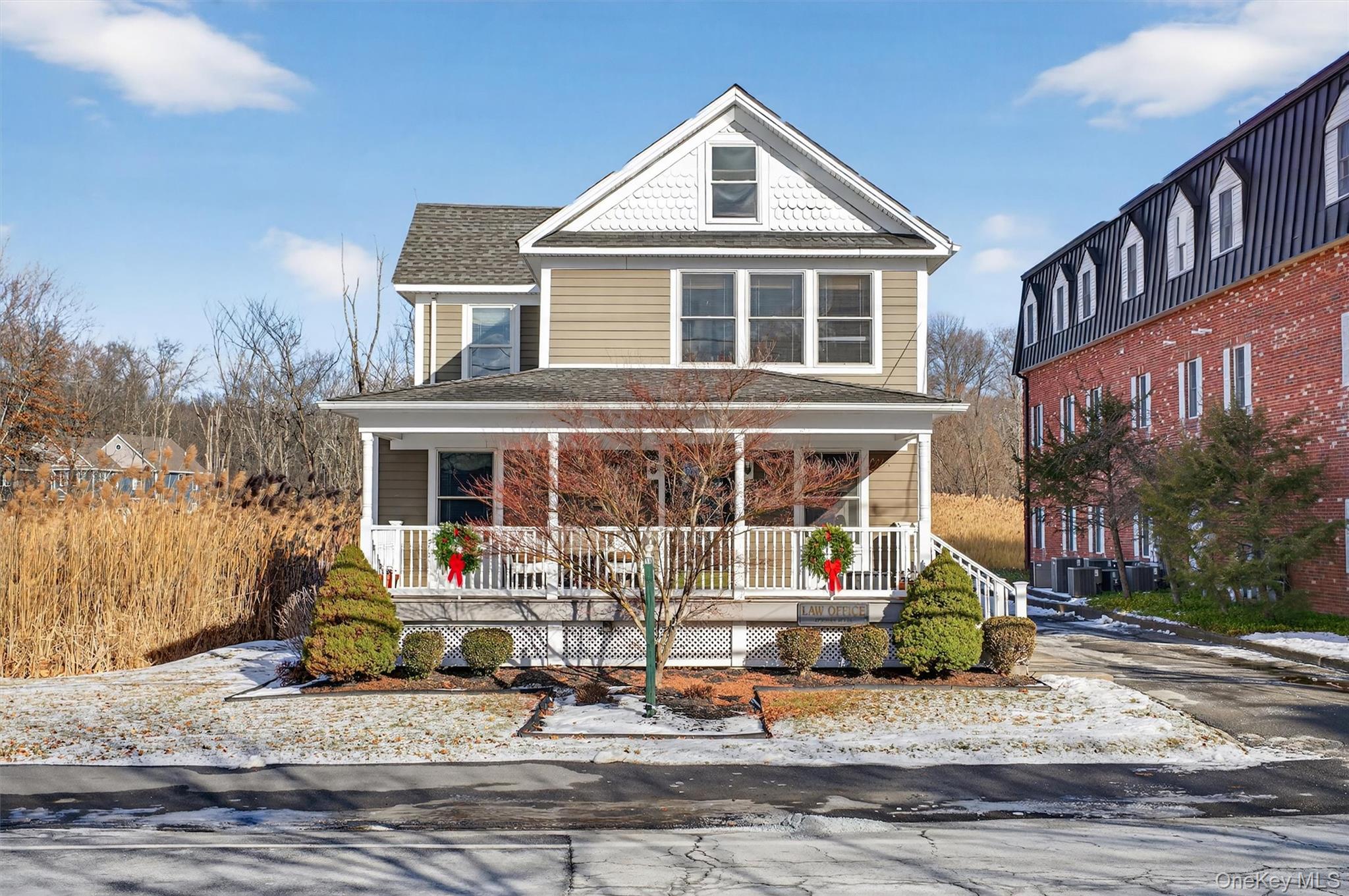 View of front of home featuring a porch and roof with shingles