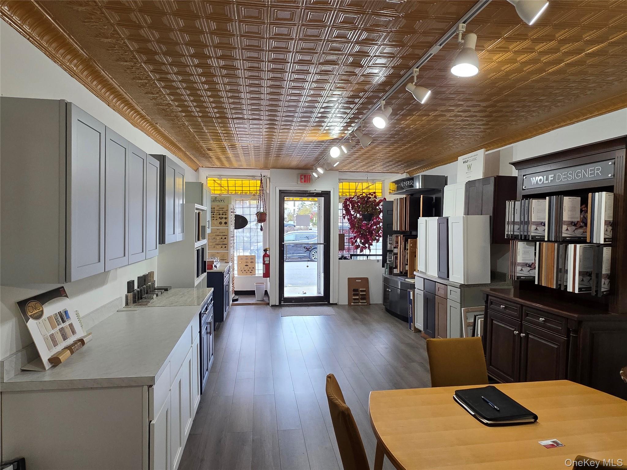 Kitchen featuring an ornate ceiling, light countertops, gray cabinets, and ornamental molding