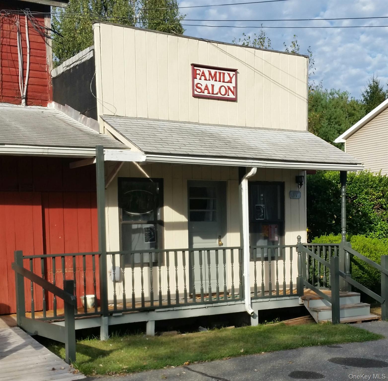 View of front of house featuring roof with shingles and covered porch