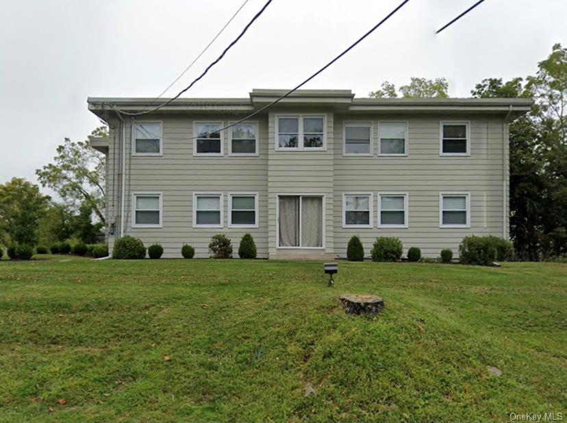 Traditional-style house featuring a front lawn