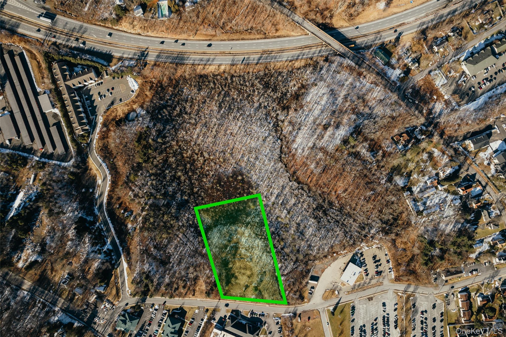 Aerial view of property and surrounding area featuring property parcel outlined