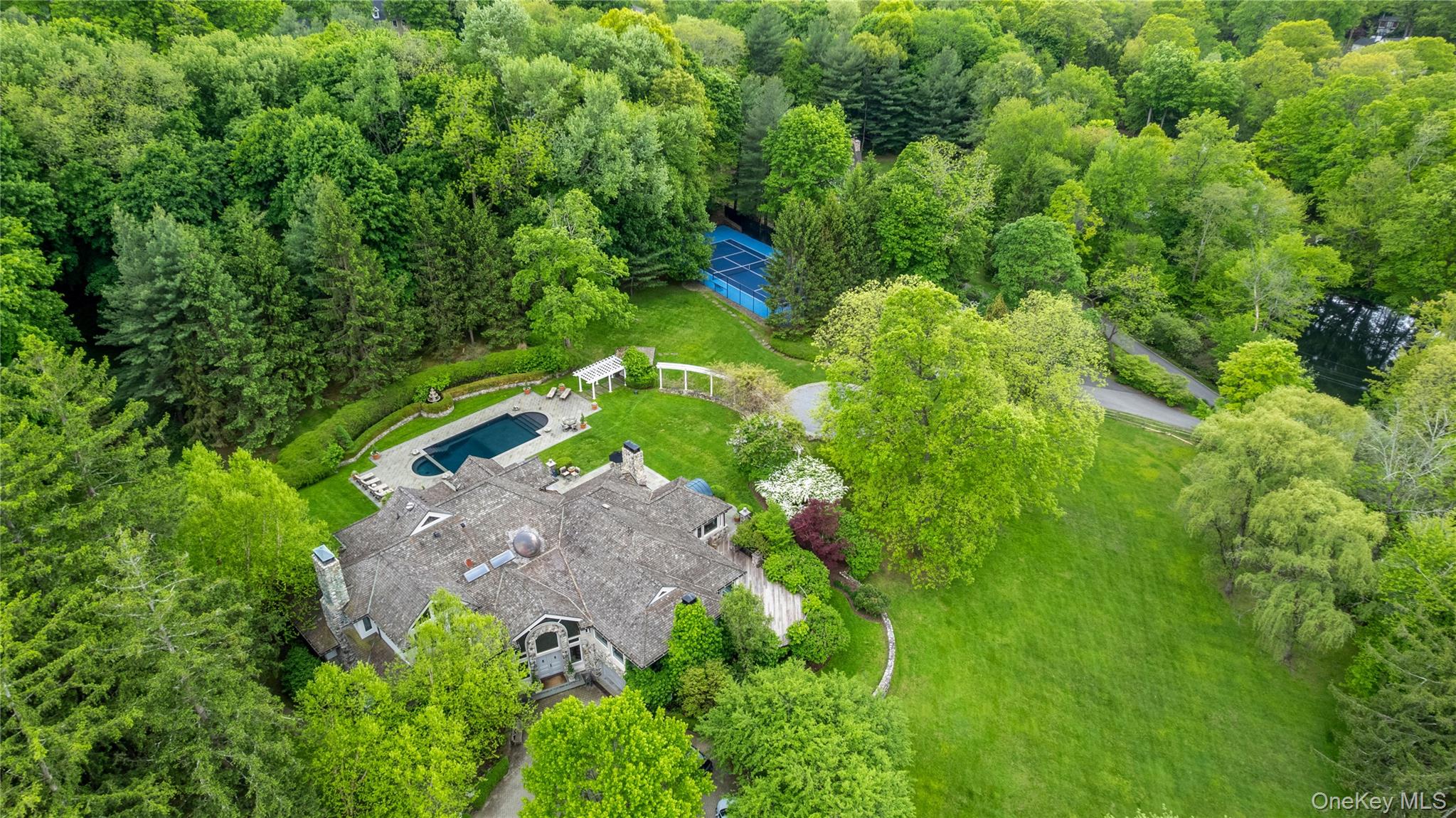 Welcome home.  150 Old Farm Road North is a gated playground with gorgeous home, pool and tennis on a hilltop setting with more than four acres.